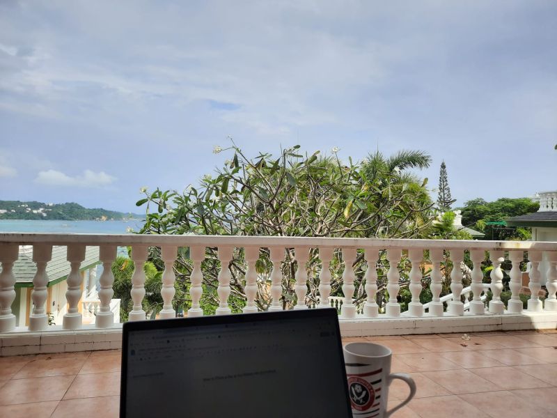 A laptop and a cup of tea on the balcony of Dominic Field iGaming writer